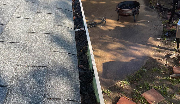Clogged gutter with dirt and debris